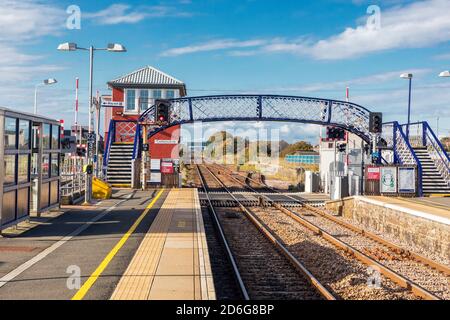 Carnoustie railway station with iron footbridge and old fashioned signal box, Carnoustie, Scotland, UK Stock Photo