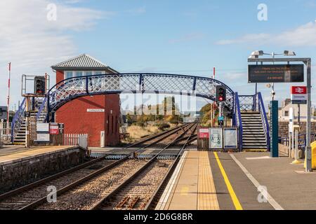 Carnoustie railway station with iron footbridge and old fashioned signal box, Carnoustie, Scotland, UK Stock Photo