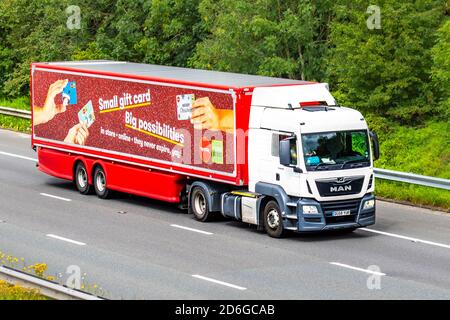 TK Maxx store red white HGV Haulage delivery trucks, lorry, transportation, truck, cargo carrier, 2018 Man TGS tractor unit vehicle, European commercial transport industry, M61 at Manchester, UK Stock Photo