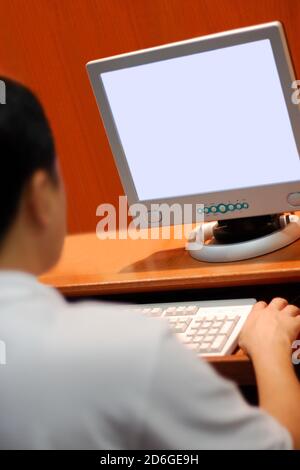 Young man looking at computer screen Stock Photo