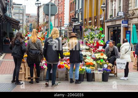 Dublin, Ireland - 10 November 2015: Street commerce on Duke Street. A stand with colorful flowers. Stock Photo