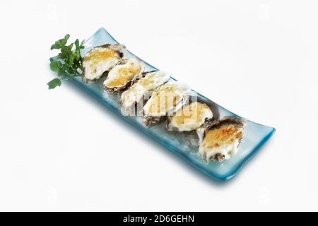 Baked oysters with cheese served on plate Stock Photo