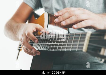 Close-up on the hands of a guitarist playing classical guitar in an unusual technique Stock Photo
