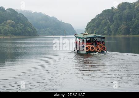 Thekkady boating in forest lake. boat safari in river Munnar Idukki Thekkadi Kerala India. major Indian wildlife tourist . Kerala tourism Stock Photo