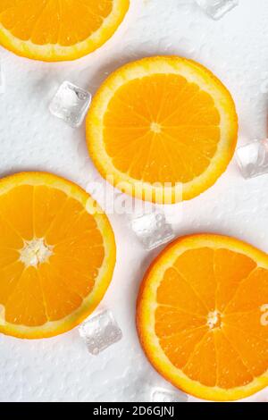 slices of orange  with ice on a white background Stock Photo
