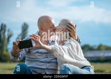 happy senior couple dating, taking selfie and have fun outdoor Stock Photo