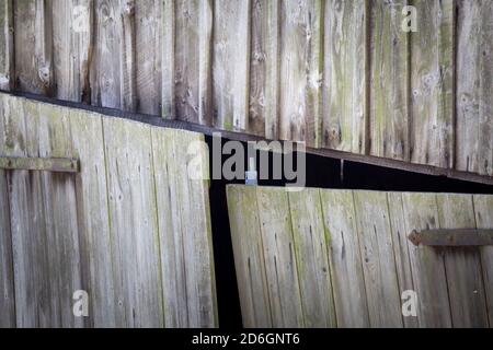 Wooden doors on a wonky old timber barn Stock Photo