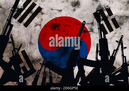 Several automatic rifles raised up on the background of the South Korea flag Stock Photo