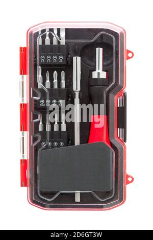 a set of working tools with a screwdriver and bits for repair in an label transparent plastic box with iron nozzles, an object isolated on a white bac Stock Photo