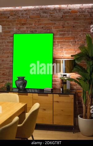 Mockup of a living room with an empty frame over a brick wall Stock Photo