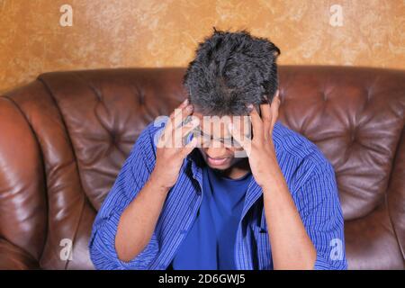 Depressed man feeling sick and worried about financial problem Stock Photo