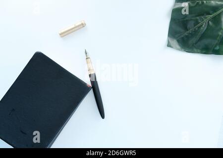 top view of a diary and fountain pen on white background  Stock Photo