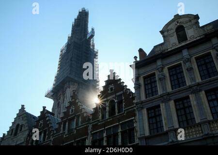 The detail of the old historic houses at the square in Belgian city of Antwerp with a tower of the cathedral under reconstruction. Stock Photo