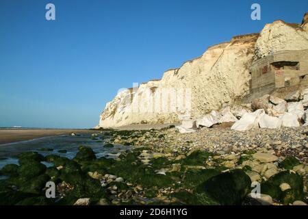 The beaches under the high white  cliffs on the shore of the Channel at Escalles in France with the ruins of the German bunkers from second world war. Stock Photo