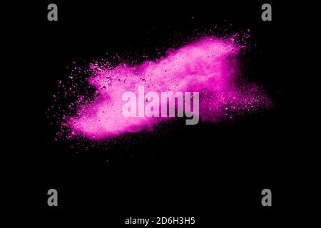 Pink dust particles splash on black background.Pink powder splash. Stock Photo