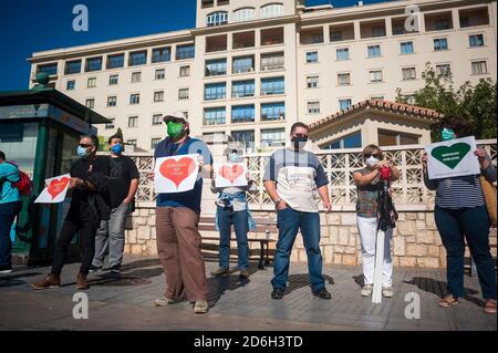 Protesters wearing face masks are seen holding up placards with a drawing of a red heart shape outside 'Regional University Hospital' during the protest against the privatization of public health service.  A nationwide demonstration of medical sector gathered under the platform 'CAS' (Anti-privatization Coordinator of Health) demand a public health system free of business privatizations. Hospitals and medical centres have been overloaded as infections and hospitalizations have increased due to the coronavirus pandemic exposing the shortcomings of a precarious public health system after cuts to Stock Photo