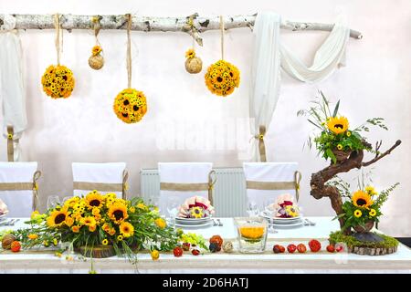 Rustic table decoration. Wedding rustic style. Natural  table decoration wiht yellow flowers. Banquet  table decoration.Luxury party decor. Stock Photo