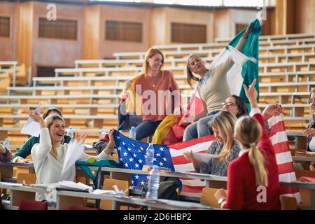 Students have good time together in the amphitheater as part of a student exchange program. Smart young people study at the college. Education, colleg Stock Photo