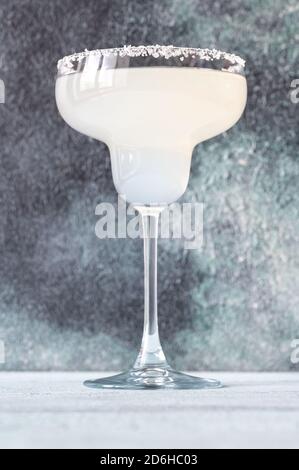 Glass of Margarita cocktail garnished with salt rim Stock Photo