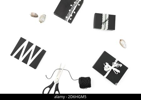 Christmas frame of stylish gifts with twine and scissors on white background. Winter holiday concept. Flat lay. Top view Stock Photo