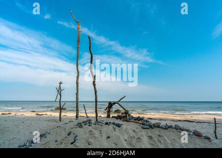 Huge sandcastle with stones and sticks at the beach in Schwarbe on the baltic sea island Ruegen Stock Photo