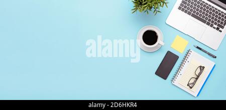 Workspace with laptop, office supplies. Stylish table desk, image with copy space on blue background Stock Photo