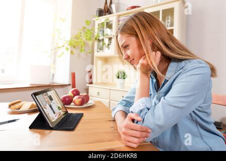 Doctor with a stethoscope on the tablet screen. Digital, remote consultation, telemedicine or telehealth concept. Stock Photo