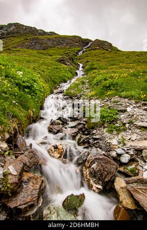Mountain stream in the Switzerland. net blue water in Swiss Alps