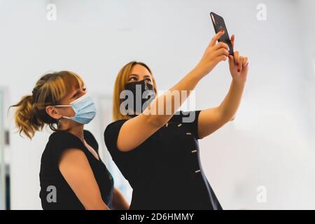 friends taking a selfie from their smartphone Stock Photo