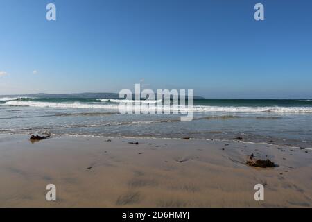 Surf waves on the sandy beach, Hayle, Cornwall, United Kingdom. 15/10/2020  surf waves on golden sand Hayle beach in the sun Stock Photo