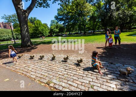 Children seated in bronze Make Way for Ducklings sculptures in Boston Public Garden, Boston, Massachusetts, USA Stock Photo