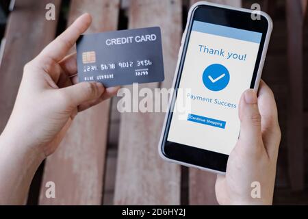 Online shopping, mobile payment. Woman hands holding credit card and using smart phone for online payment Stock Photo