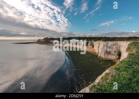 Broadstairs, Kent / UK -  2020.08.01: Empty Kingsgate Beach and Castle on the cliffs above the Bay, on cloudy autumn morning. Stock Photo