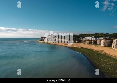 Broadstairs, Kent / UK -  2020.08.01: Empty Kingsgate Beach and Castle on the cliffs above the Bay, on cloudy autumn morning. Stock Photo