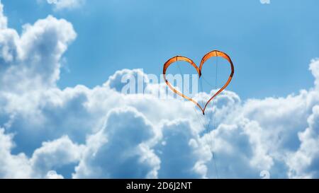 Sunlit heart-shaped dragon, orange heart in front of blue sky, North Rhine-Westphalia, Germany Stock Photo