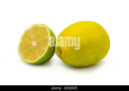 Whole and half lemons on isolated white background Stock Photo