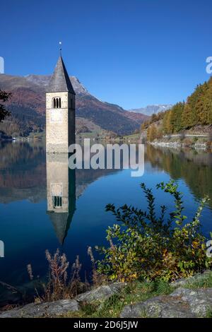 Sunken church tower in the reservoir at the Reschenpass, Graun, Vinschgau, South Tyrol, Italy Stock Photo