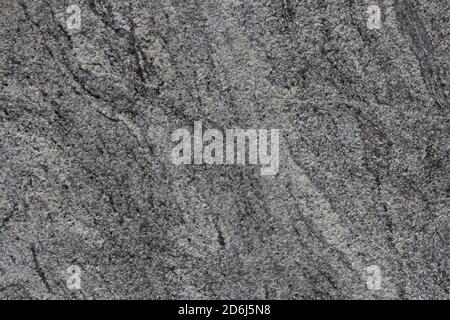 The texture of a natural stone slab from polished granite. Stock Photo