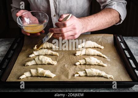 Baking sheet of raw croissants stuffed with chocolate spread Stock Photo