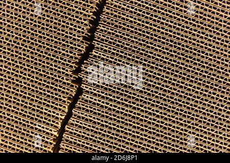 Abstract image of stacked corrugated cardboard boxes in a factory setting Stock Photo