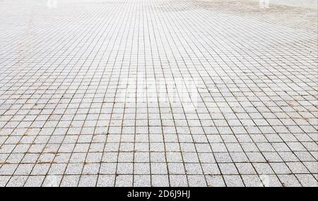 Stone sidewalk. Paving stones on roads and sidewalks in the old part of the city. Paving stone material background. Granite, cobblestone. Concrete pav Stock Photo