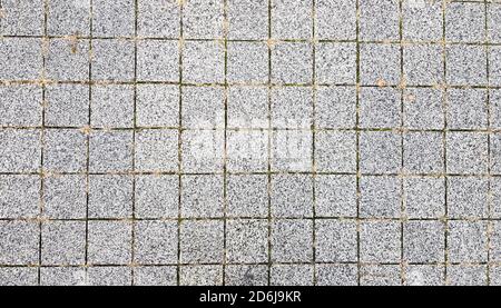 Stone sidewalk. Paving stones on roads and sidewalks in the old part of the city. Paving stone material background. Granite, cobblestone. Concrete pav Stock Photo