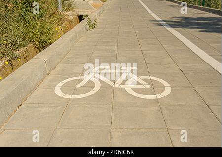 white bicycle silhouette sign, painted on path with bikeway Stock Photo