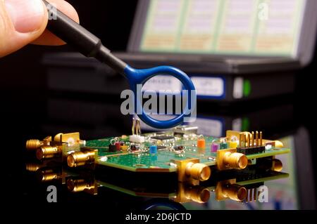 Electromagnetic compatibility (EMC) engineer holding magnetic near field probe for EMC troubleshooting and measurements Stock Photo