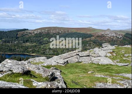 View from the top of Sheepstor, Dartmoor National Park, with open moorland, Sharpitor, Leather Tor and Burrator Reservoir on a sunny day. Stock Photo