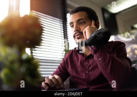African businessman or developer wearing surgical face mask in the restaurant and typing on laptop - concept on new normal everyday lifestyle and peop Stock Photo