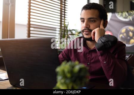 African businessman or developer wearing surgical face mask in the restaurant and typing on laptop - concept on new normal everyday lifestyle and peop Stock Photo