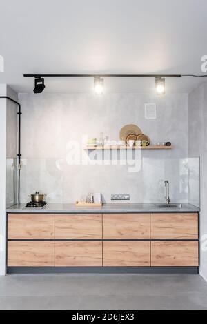 Spacious, minimalistic kitchen with concrete walls Stock Photo