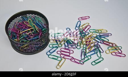 Colourful paper clips and a black container Stock Photo