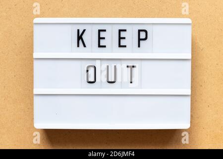 Lightbox with word keep out on wood background Stock Photo
